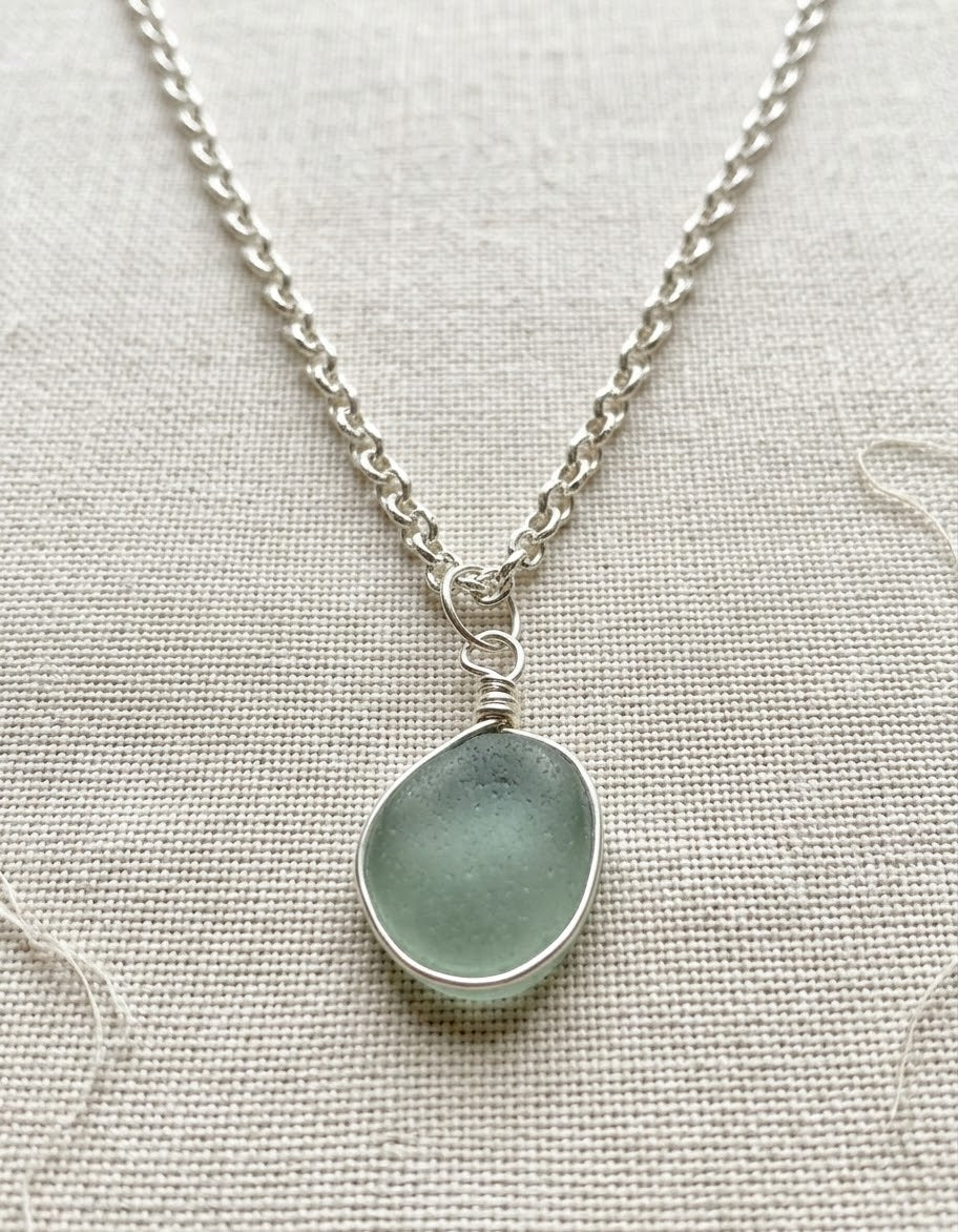 Decorative outer wrapped seaglass pendant on jewellers wire and a silver plated chain
